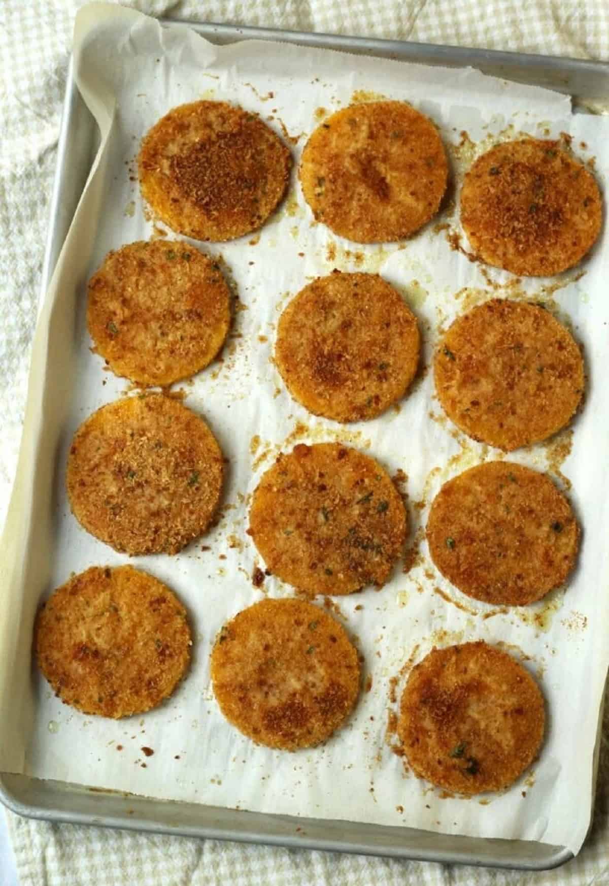 Baked butternut squash cutlets on baking sheet.