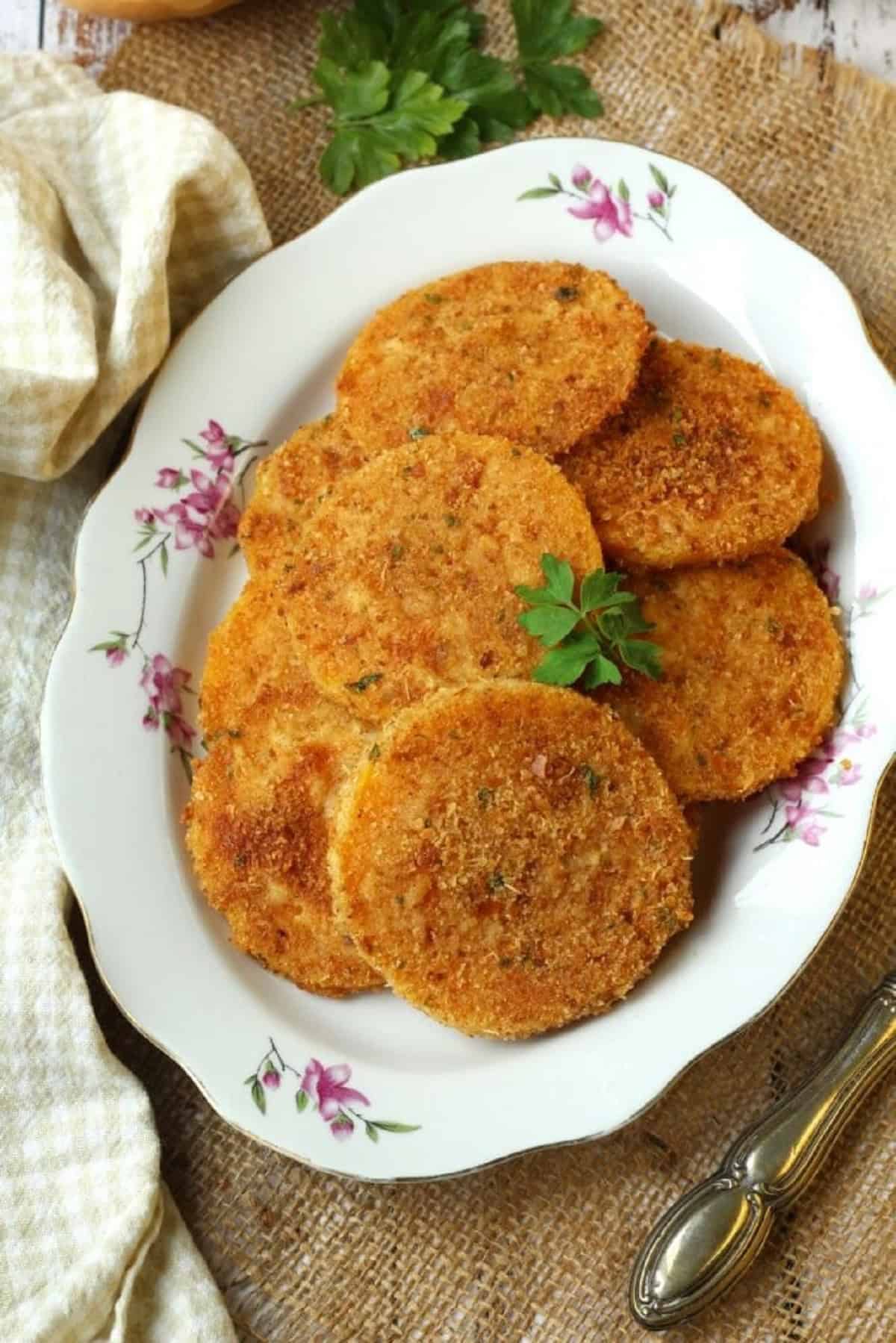 Baked butternut squash cutlets piled on plates.