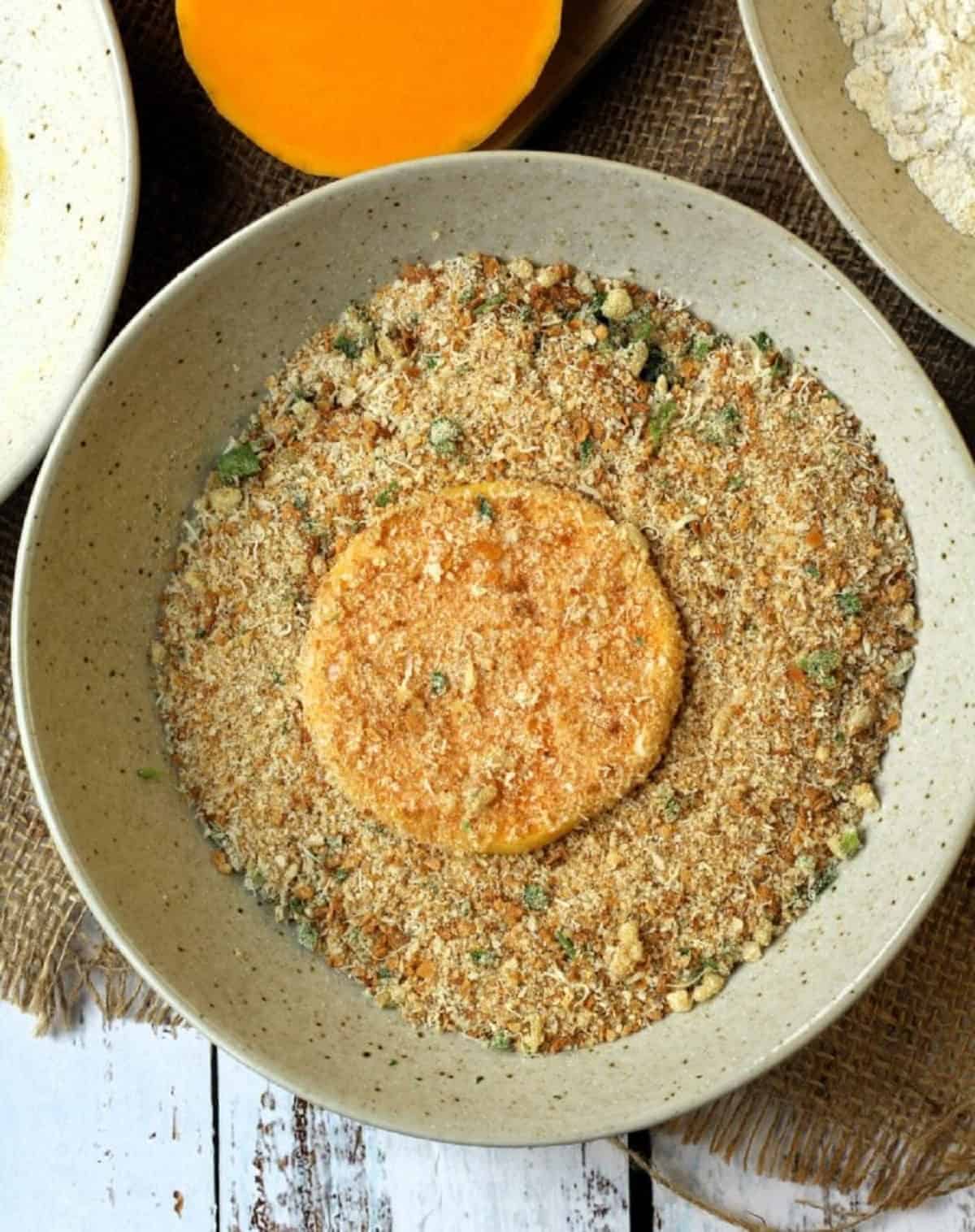 Dredged butternut squash cutlets in breadcrumbs.