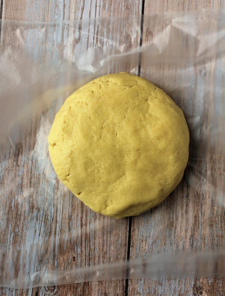 Cuccidati cookie dough shaped into disc form.