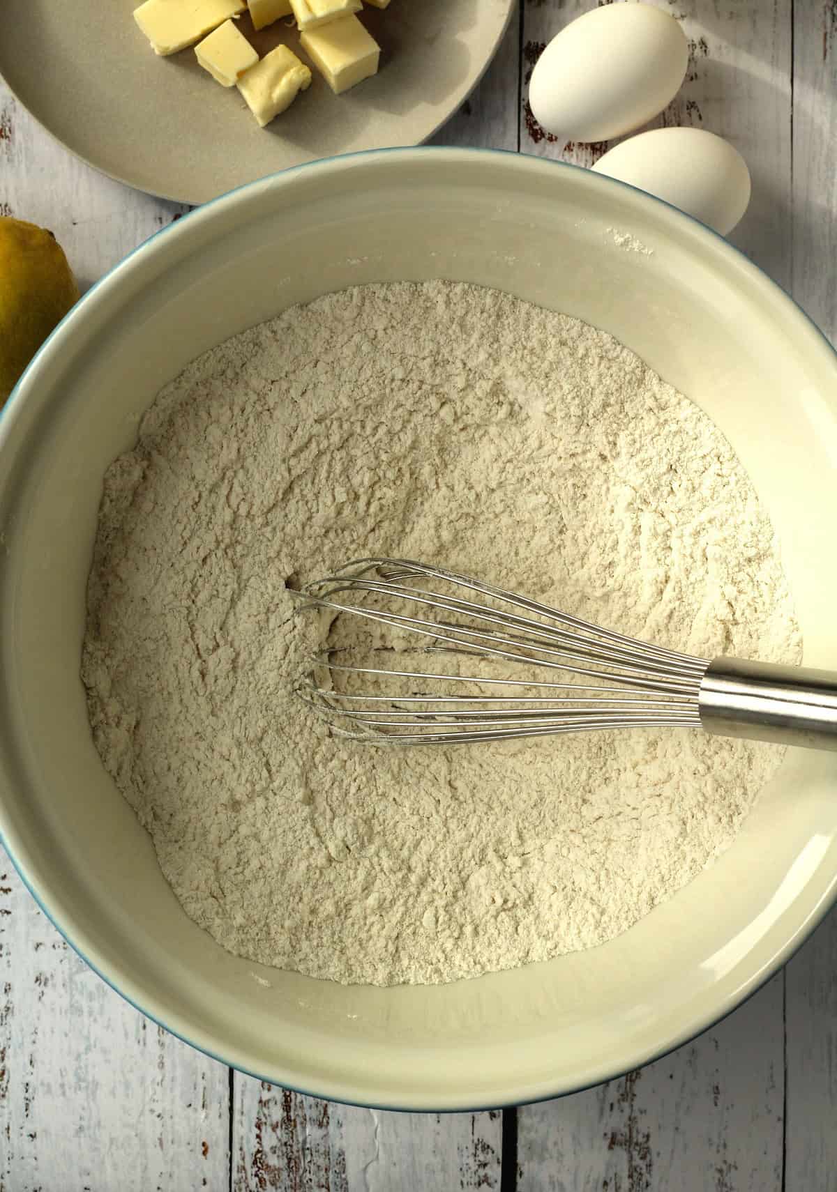Dry ingredients for lemon anise taralli whisked in large bowl.