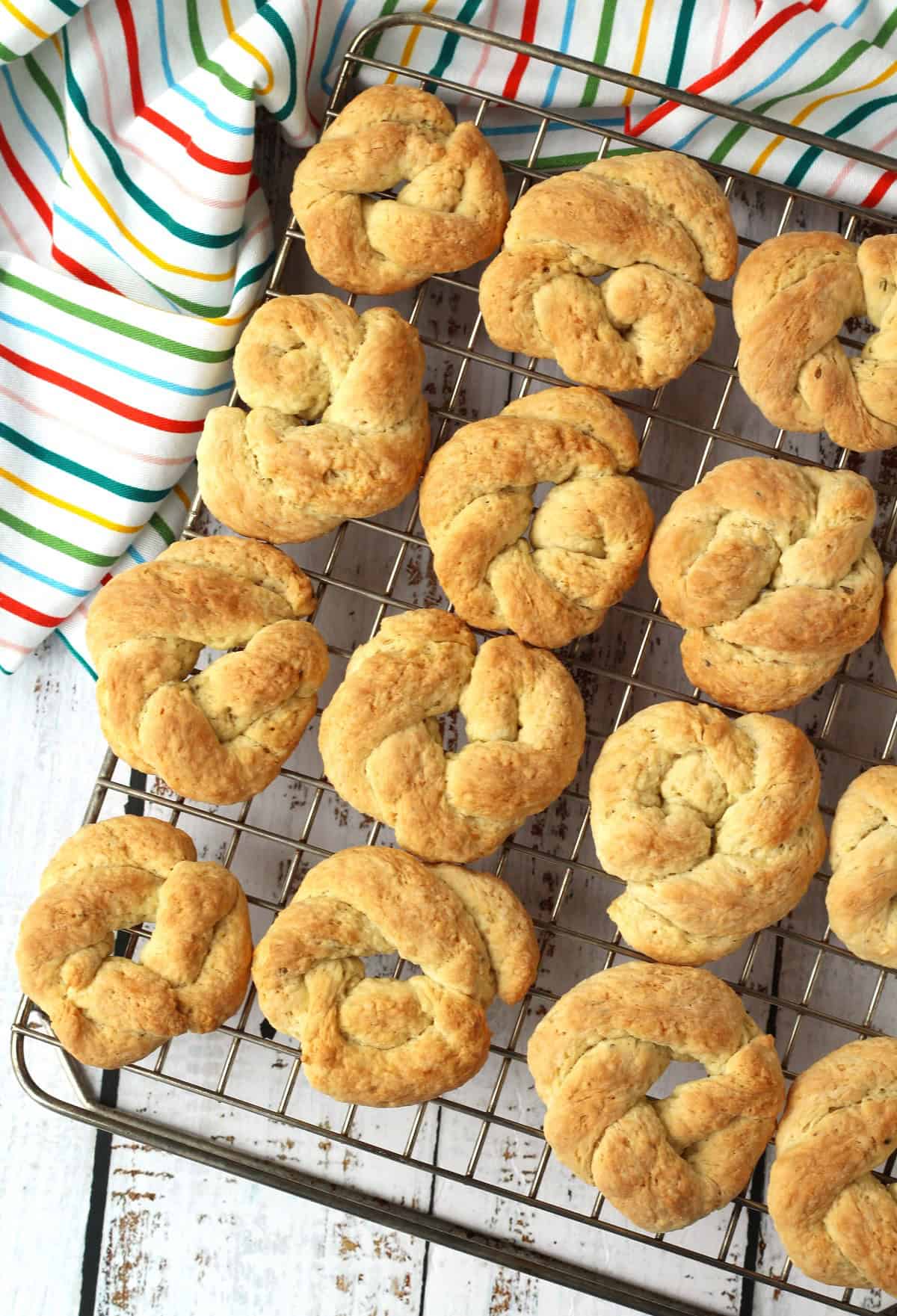 Just baked anise lemon taralli cookies resting on wire rack.