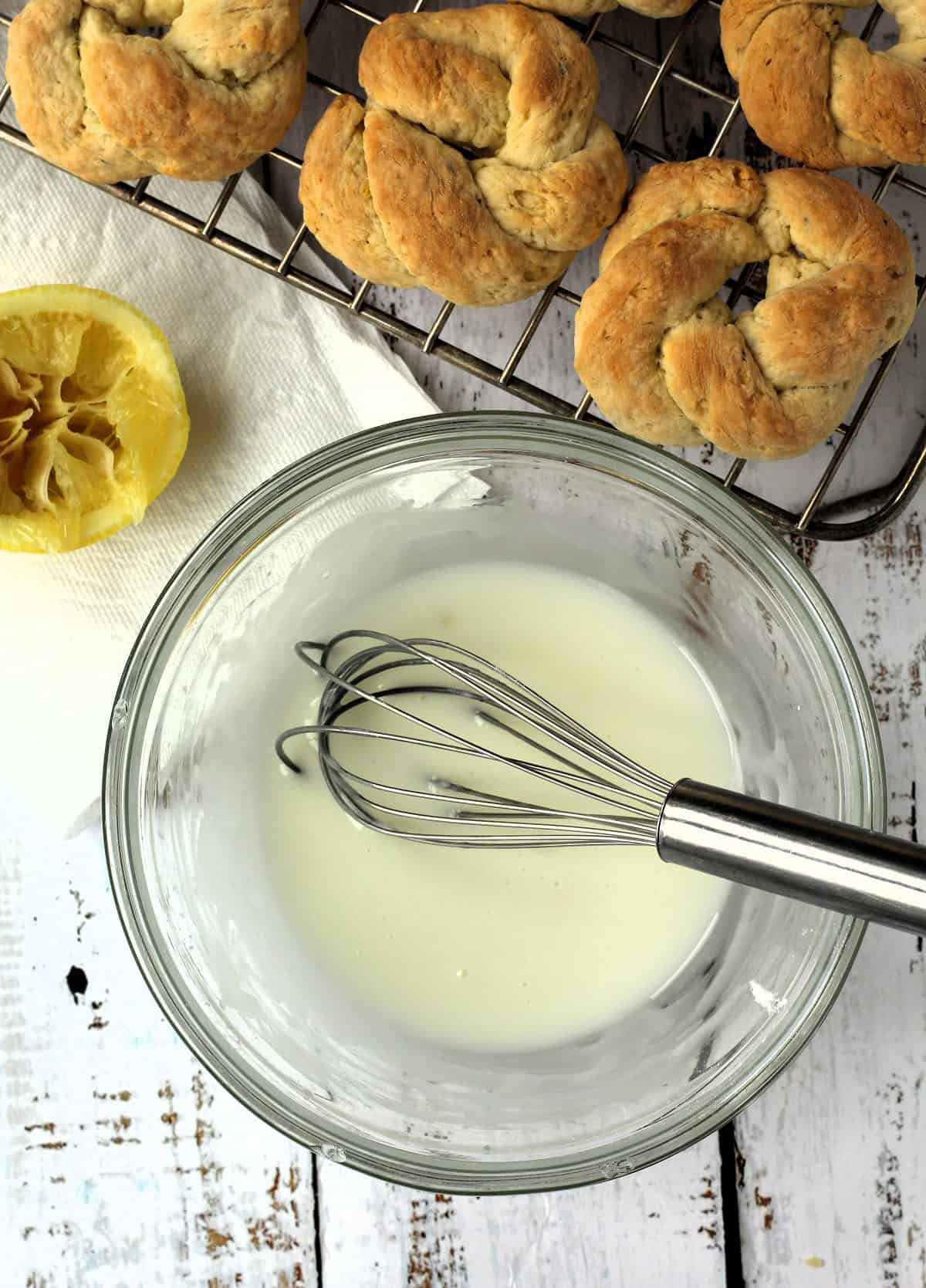 Lemon glaze for taralli cookies whisked in glass bowl.
