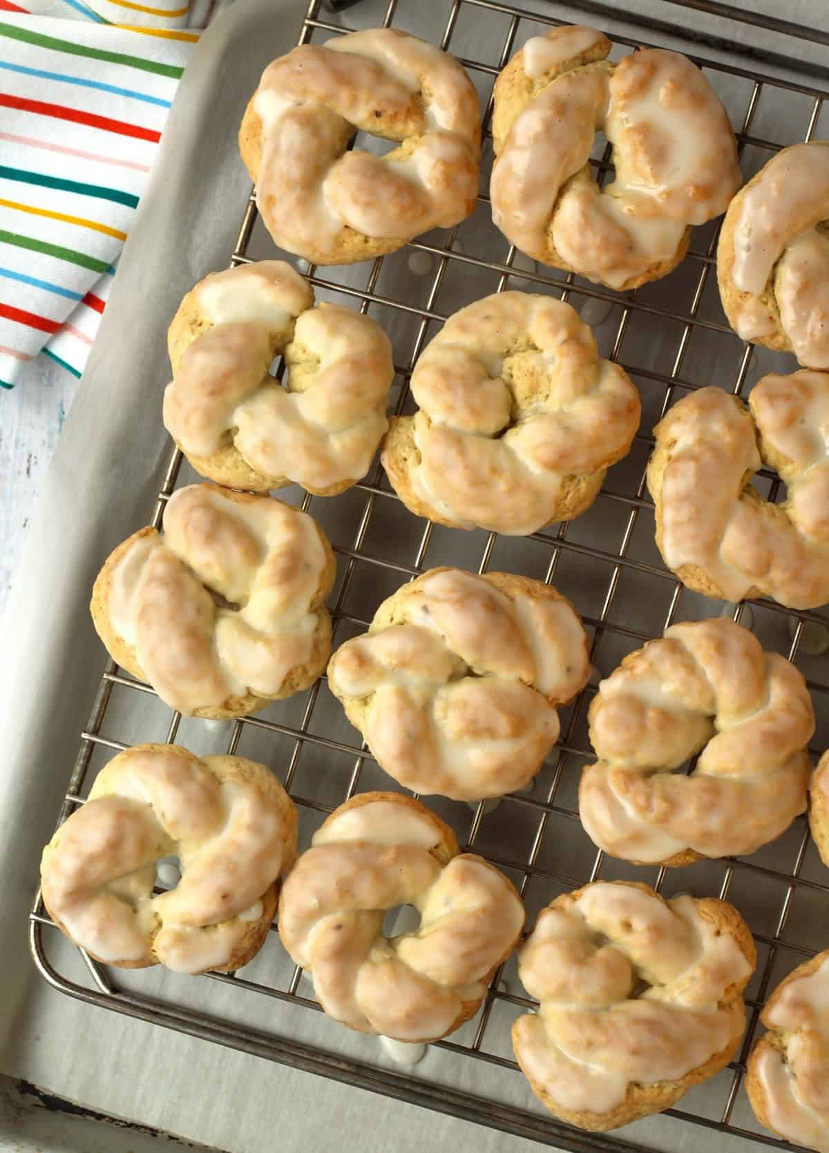 Lemon glazed anise lemon taralli cookies on wire rack.