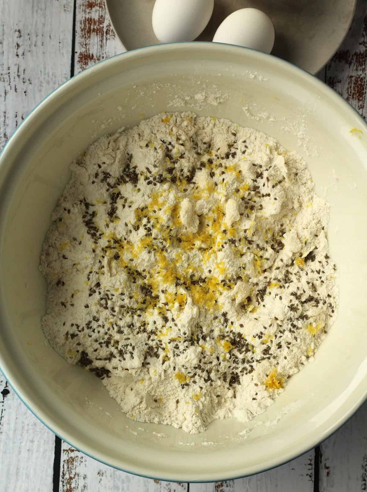 Anise seed and lemon zest added to bowl with dry ingredients.