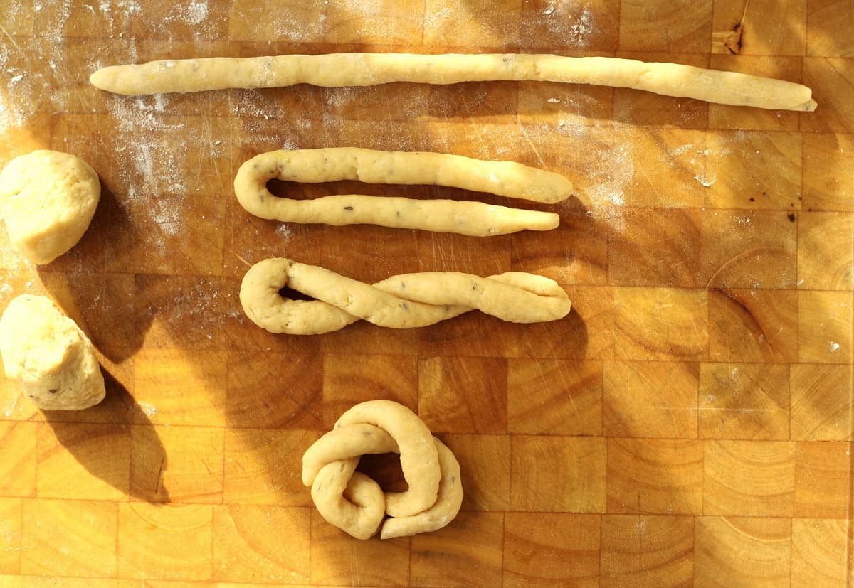 Lemon anise taralli dough strips rolled and twisted together to form a circle.