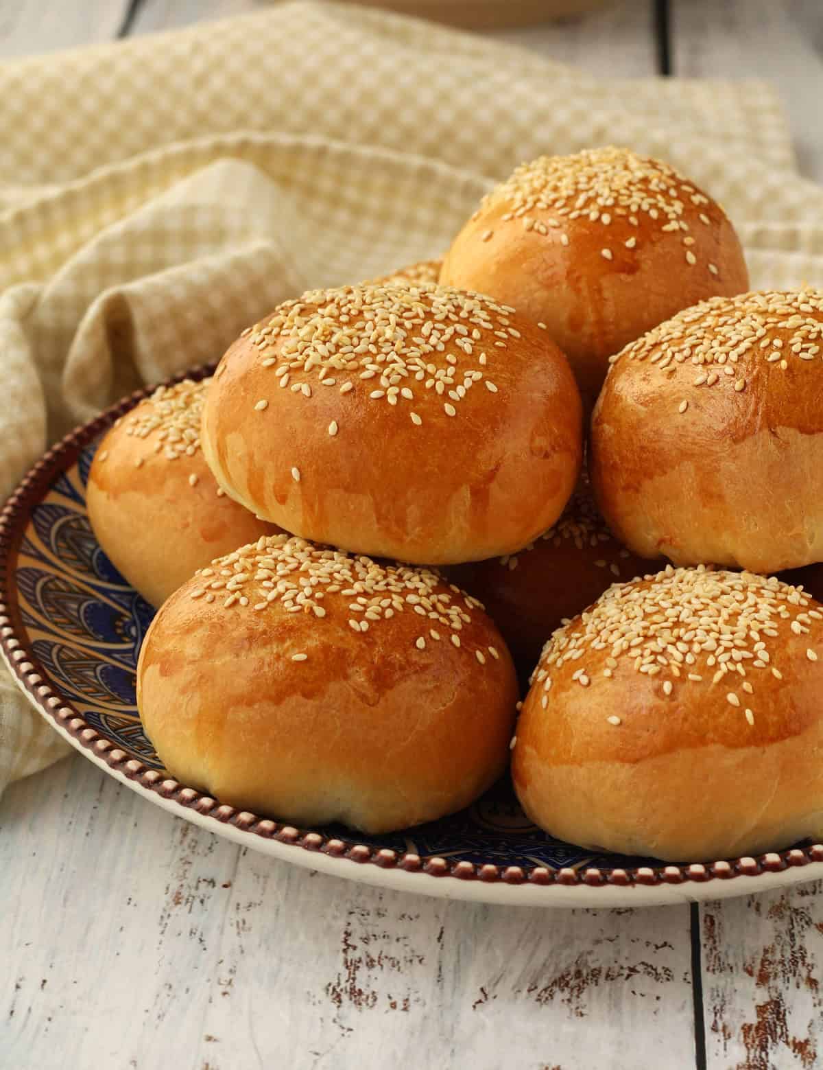 Spinach and ricotta brioche buns (ravazzate) piled on plate.