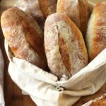 Italian panini bread rolls in cloth bread bag.
