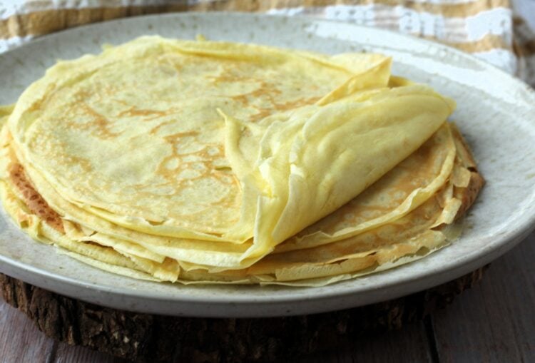 Stack of crepes on plate.