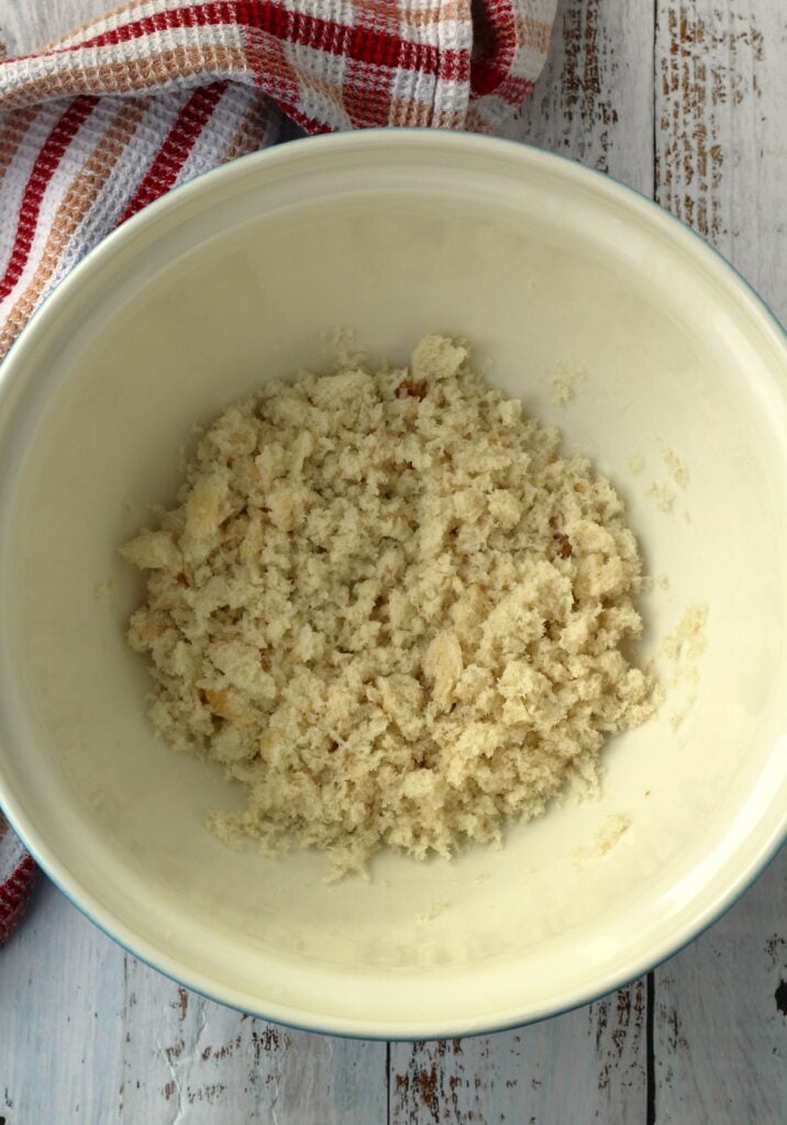 Breadcrumbs in bowl tossed with milk.