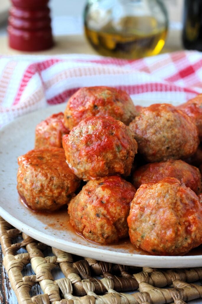 Meatballs with cheese piled on plate.