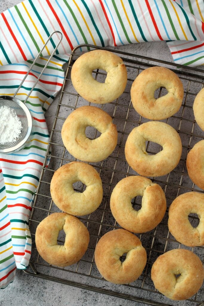 Ricotta ring cookies baked on wire rack.