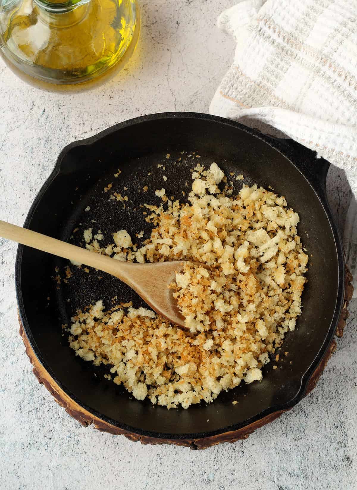 Crispy sautéed muddica in cast iron pan.