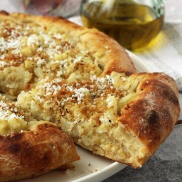 Wedge of cauliflower topped pizza with crispy breadcrumbs and ricotta salata.