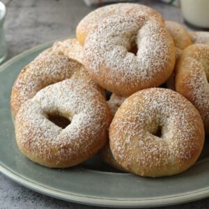 Ciambelline di ricotta ring cookies piled on round plate.