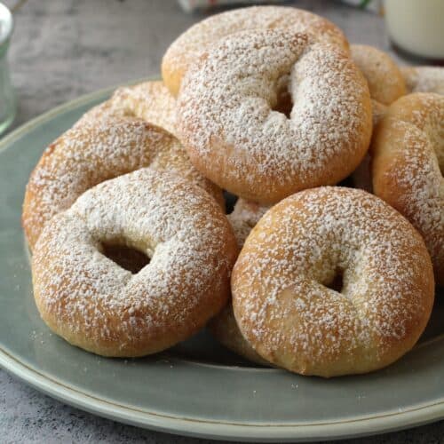 Ciambelline di ricotta ring cookies piled on round plate.