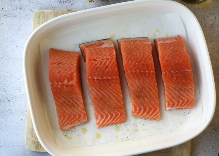 Salmon fillets on baking dish.