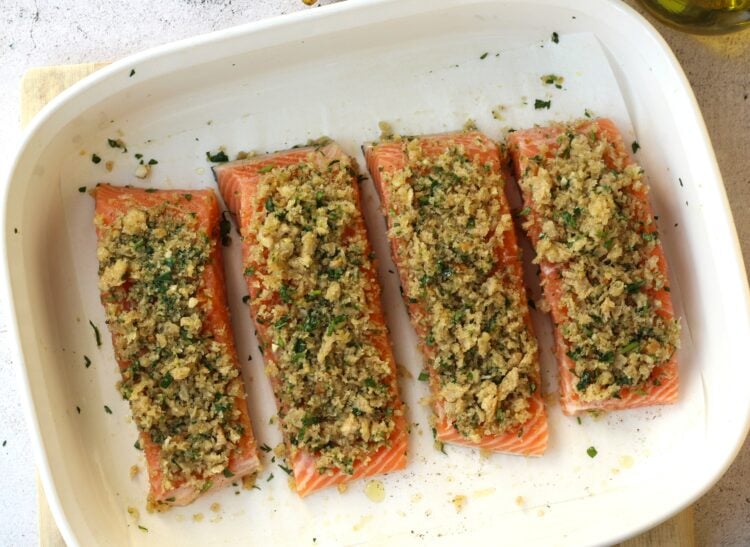 Salmon with garlic lemon breadcrumb topping on baking dish.