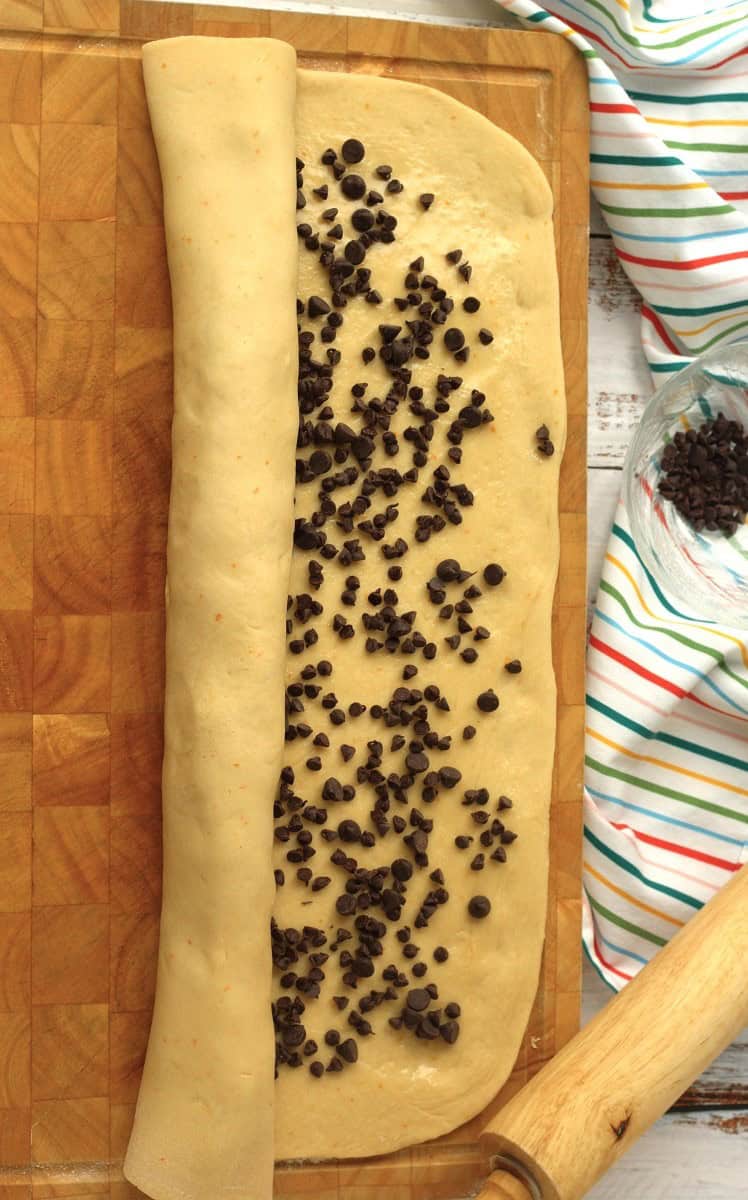 Chocolate chip topped brioche bread rolled into a cylinder.