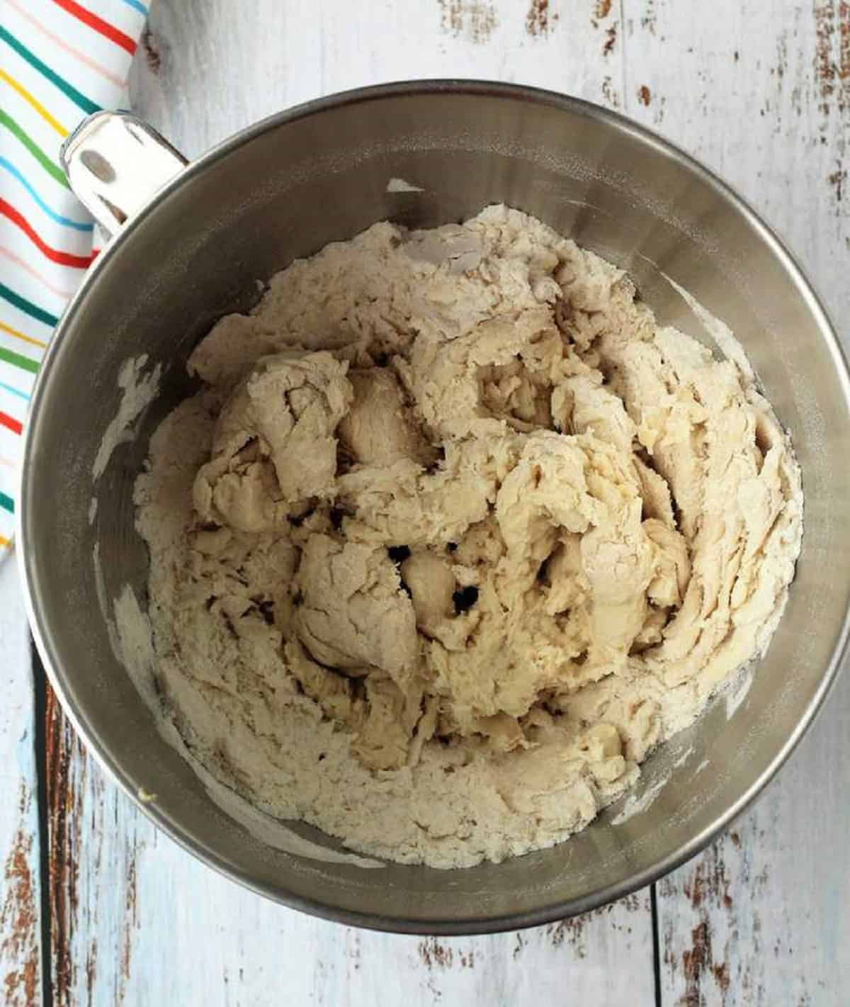 Shaggy brioche dough in bowl of food processor.