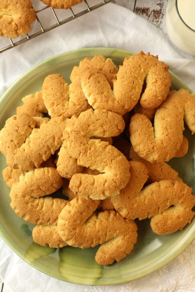 Plate piled with Italian S shaped cookies.
