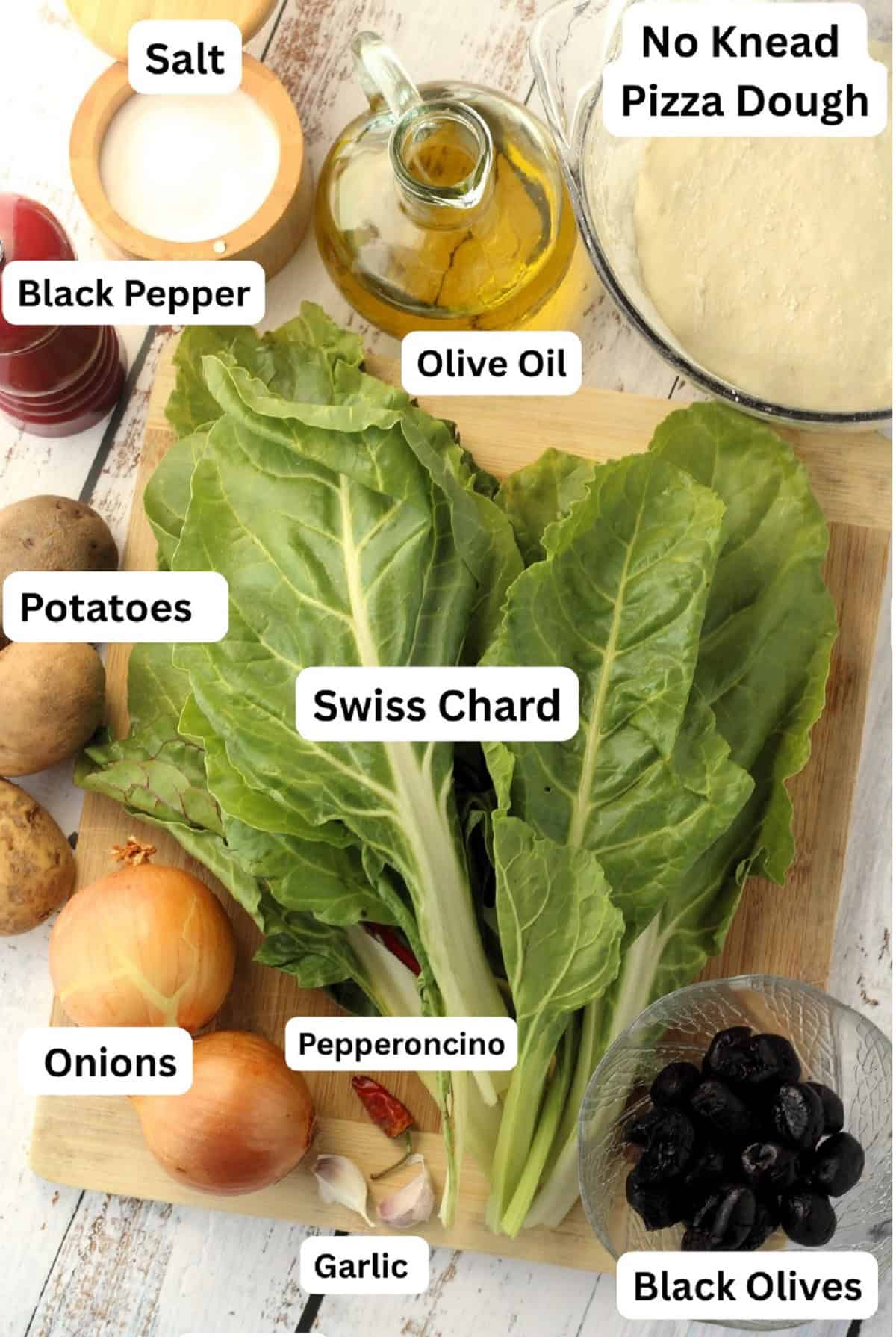 Pizza dough, swiss chard, olives, garlic, pepperoncino, onions, potatoes, salt, pepper and olive oil.