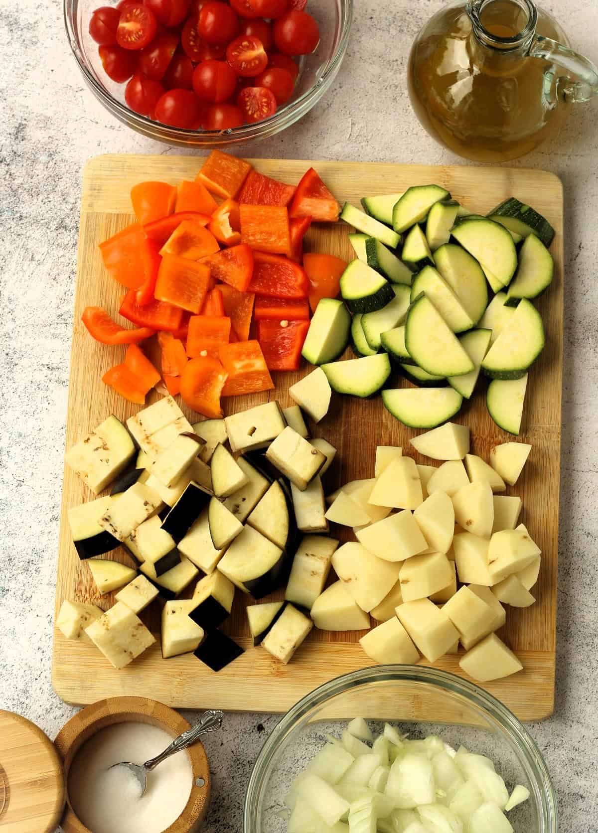Cubed peppers, zucchini, eggplant, potatoes, onions, cherry tomatoes, olive oil and salt for canazzo.