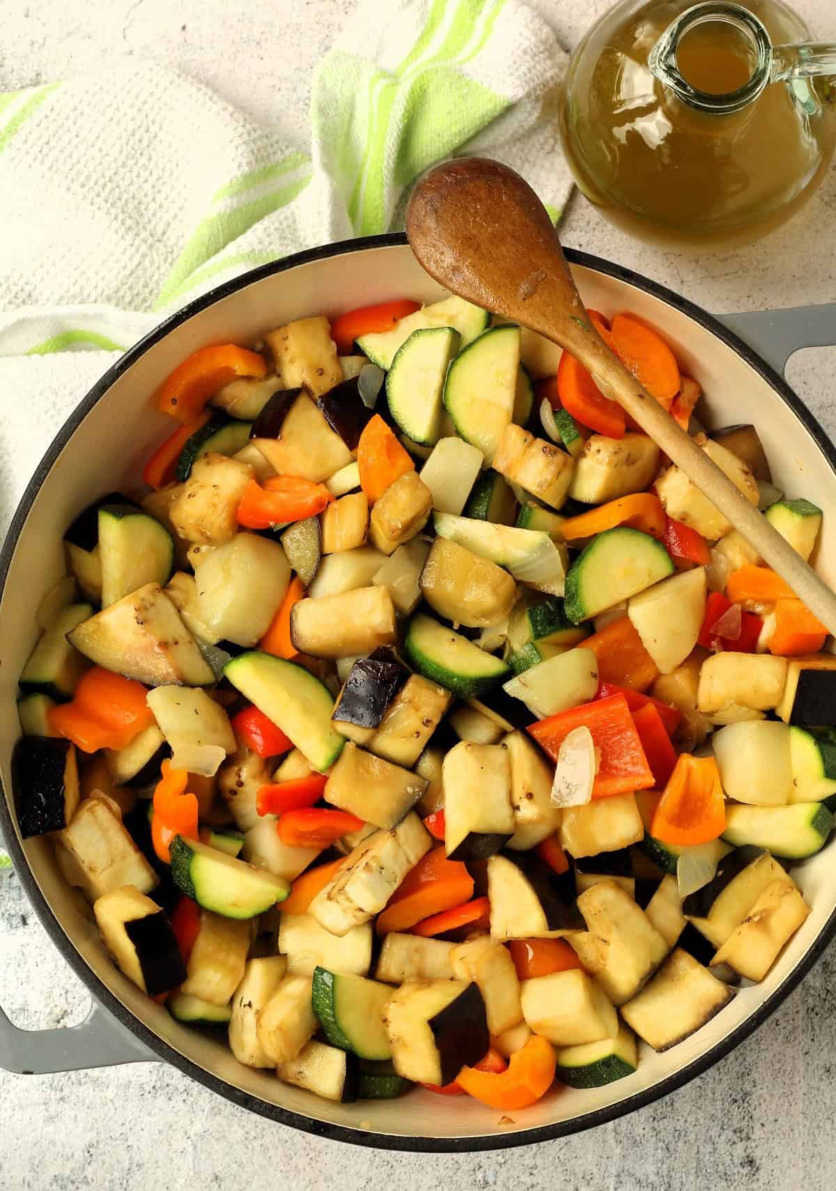 Diced peppers, zucchini, eggplant, potatoes and onions in skillet for canazzo recipe.