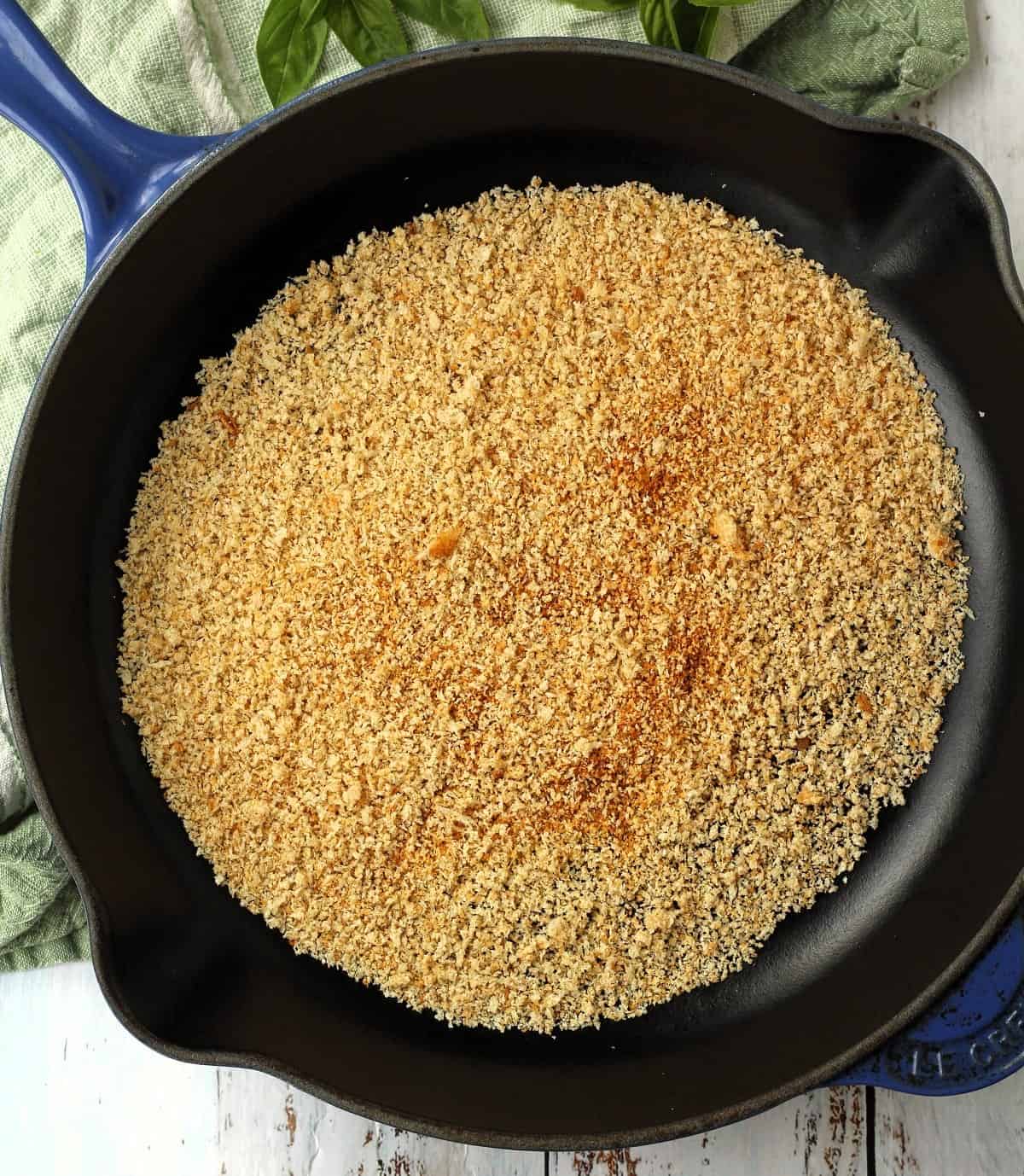Muddica (breadcrumbs) toasted in cast iron skillet.