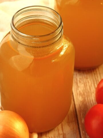 Homemade vegetable broth in mason jars.