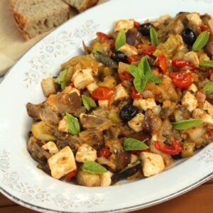 Sicilian eggplant caponata with swordfish in oval plate.
