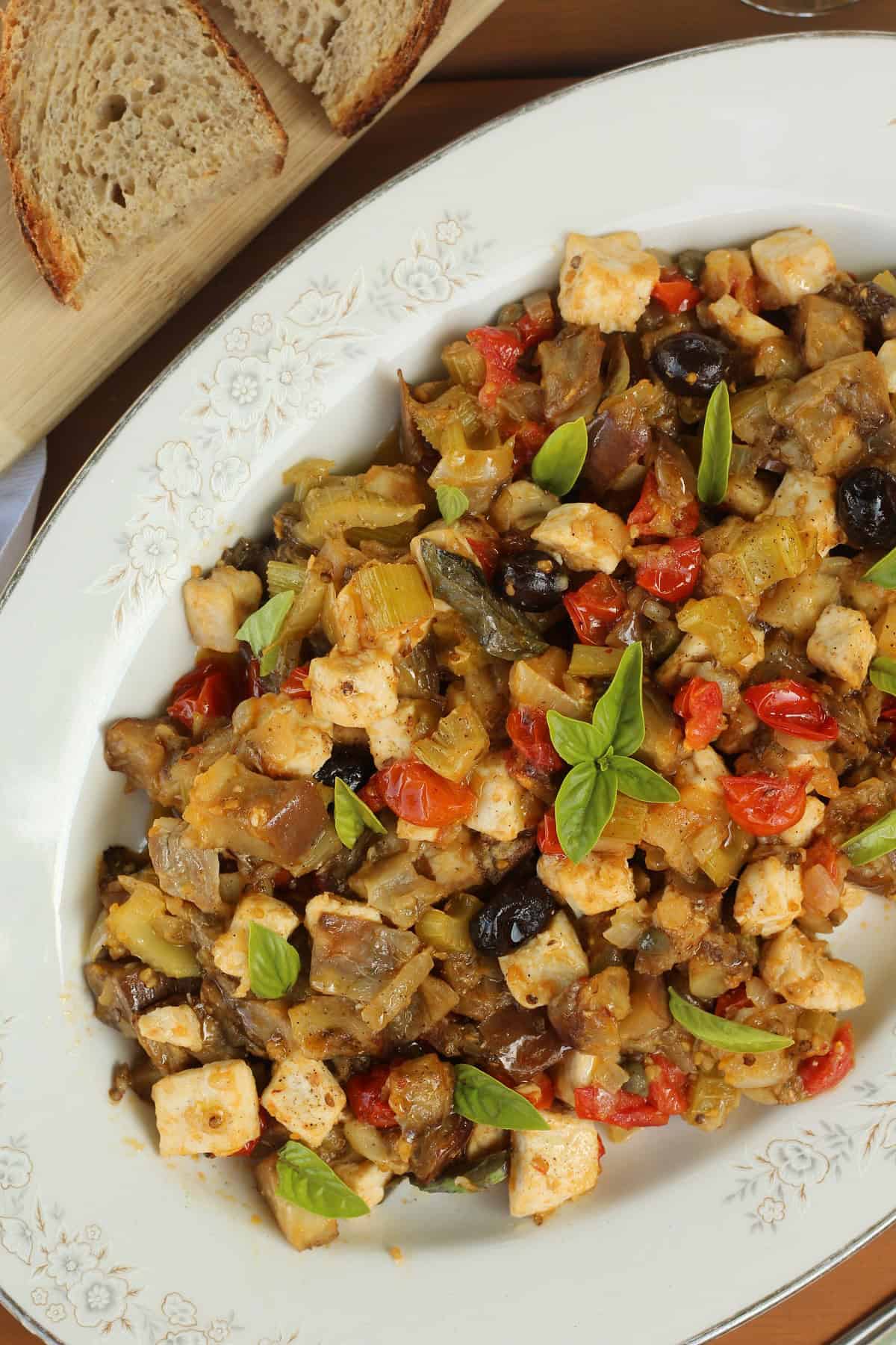 Oval plate with eggplant caponata with swordfish.