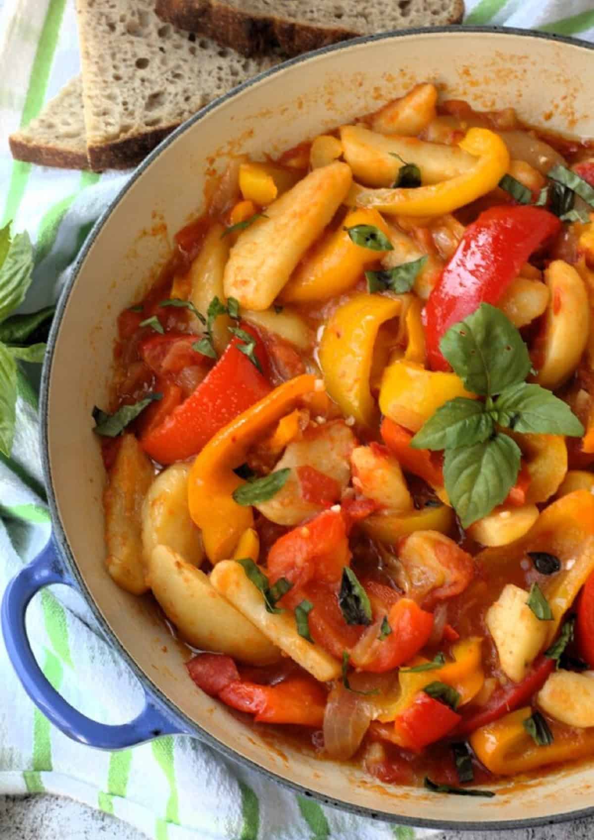 Italian stewed peppers with potatoes and tomatoes in skillet.