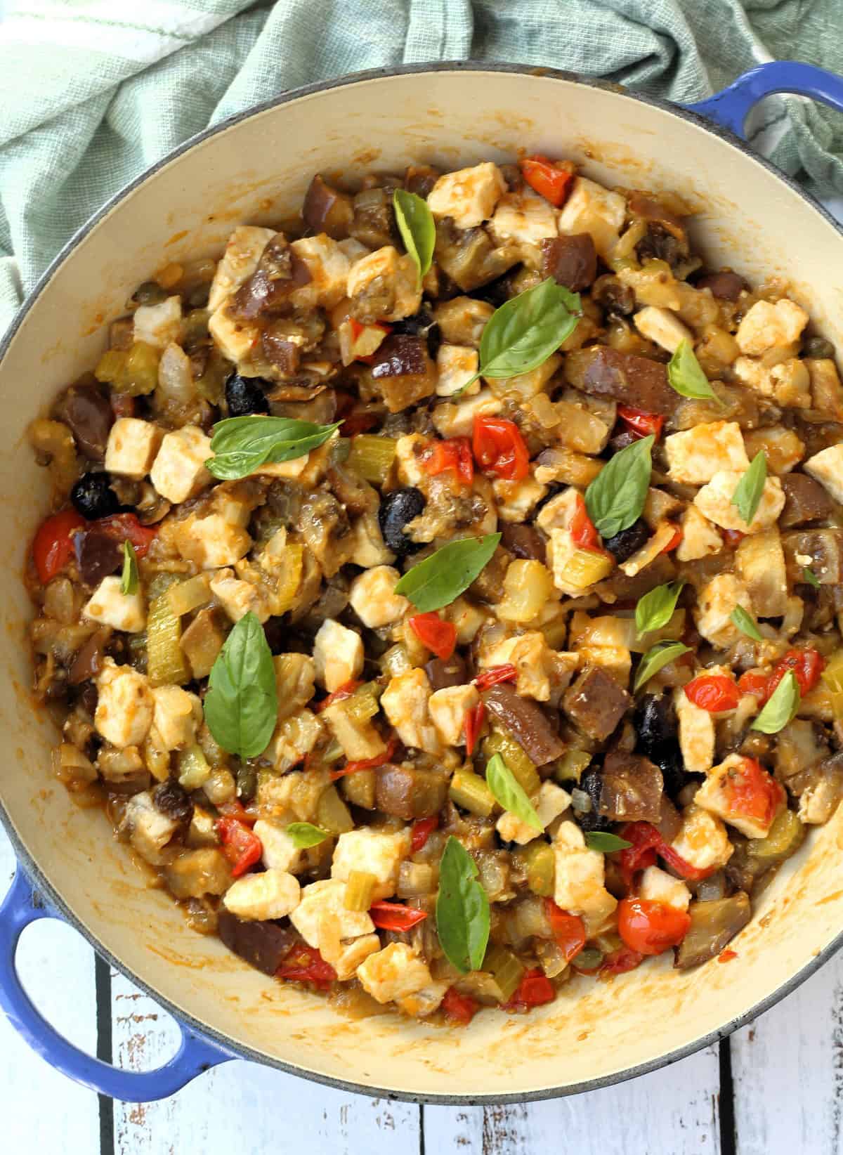 Large skillet filled with eggplant and swordfish caponata.