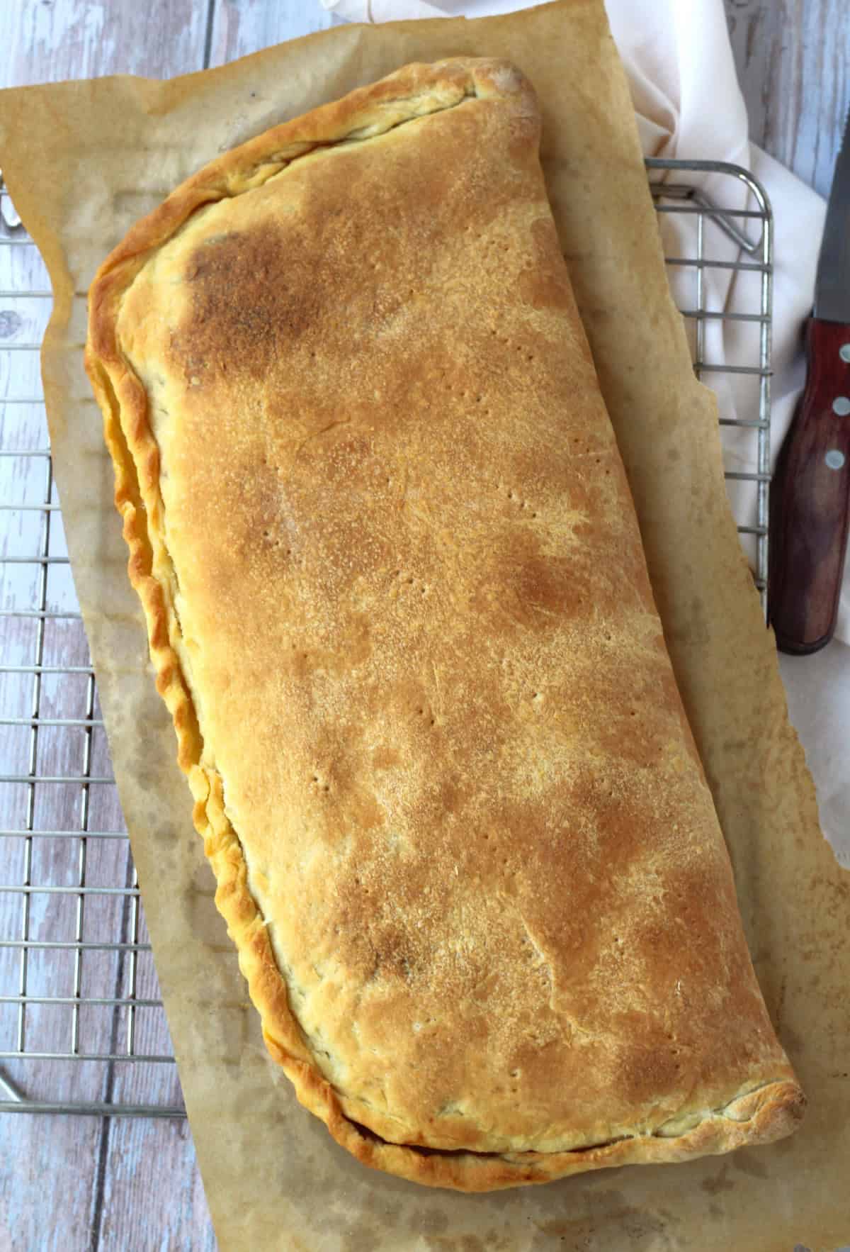 Just baked half moon shaped cudduruni pizza filled with onions.