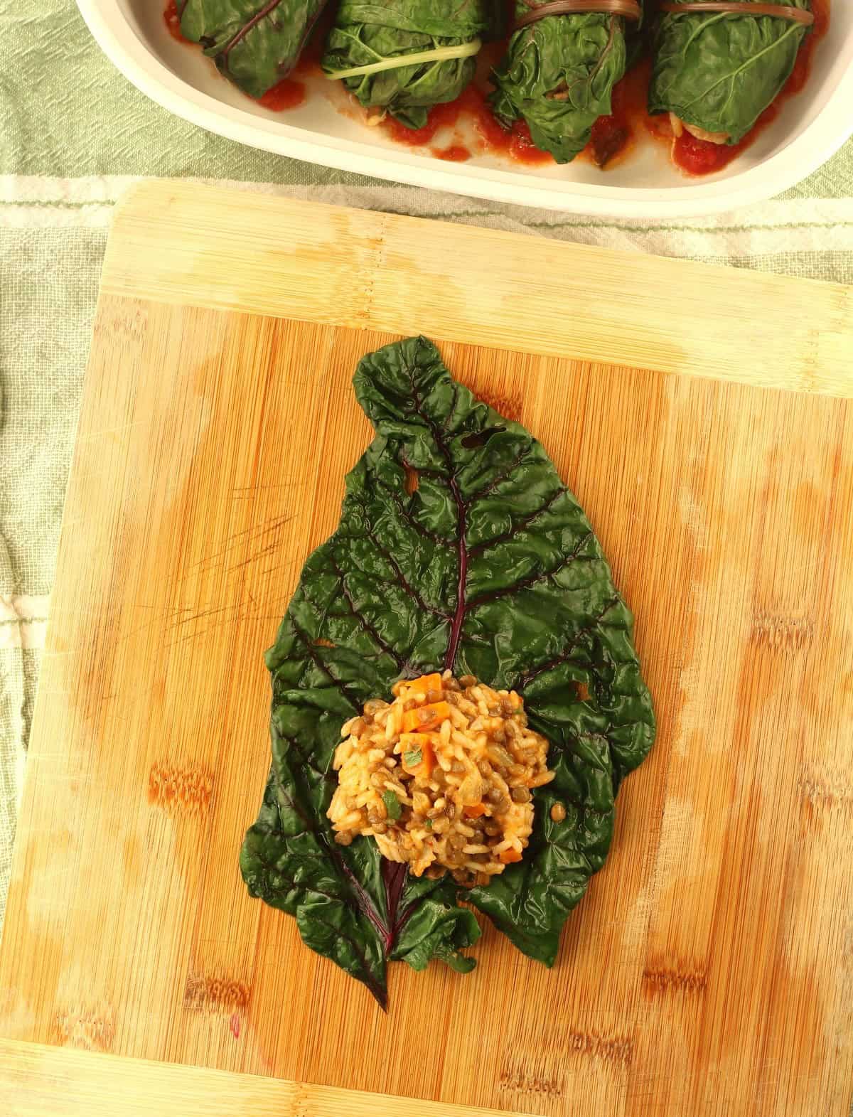 Lentil and rice mixture dollop on swiss chard leaf.