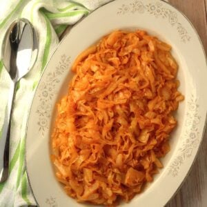 Sicilian sweet and sour cabbage on oval plate with spoon on side.