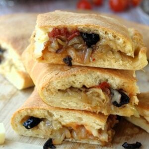 Sicilian cudduruni with onions and olives piled.