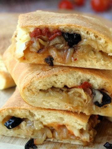 Sicilian cudduruni with onions and olives piled.