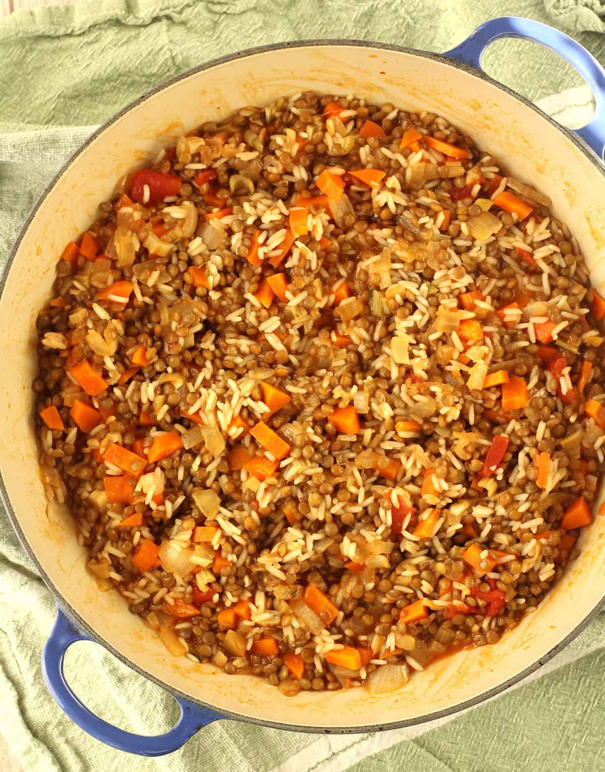 Lentils and rice filling for swiss chard rolls in skillet.