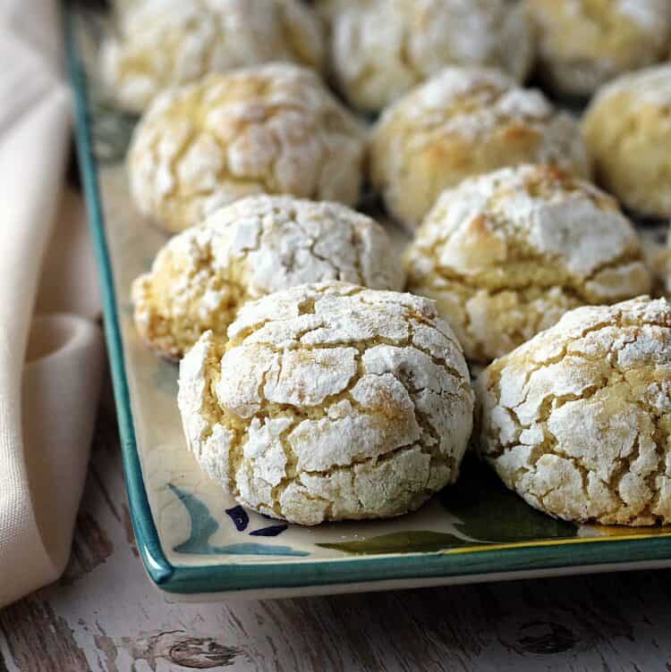 Soft lemon cookies with almond flour on rectangular plate.