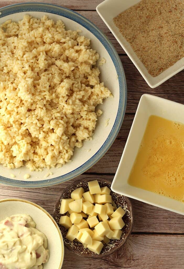 Assembling station for arancini with rice; breadcrumbs; egg wash; cheese and bechamel sauce.