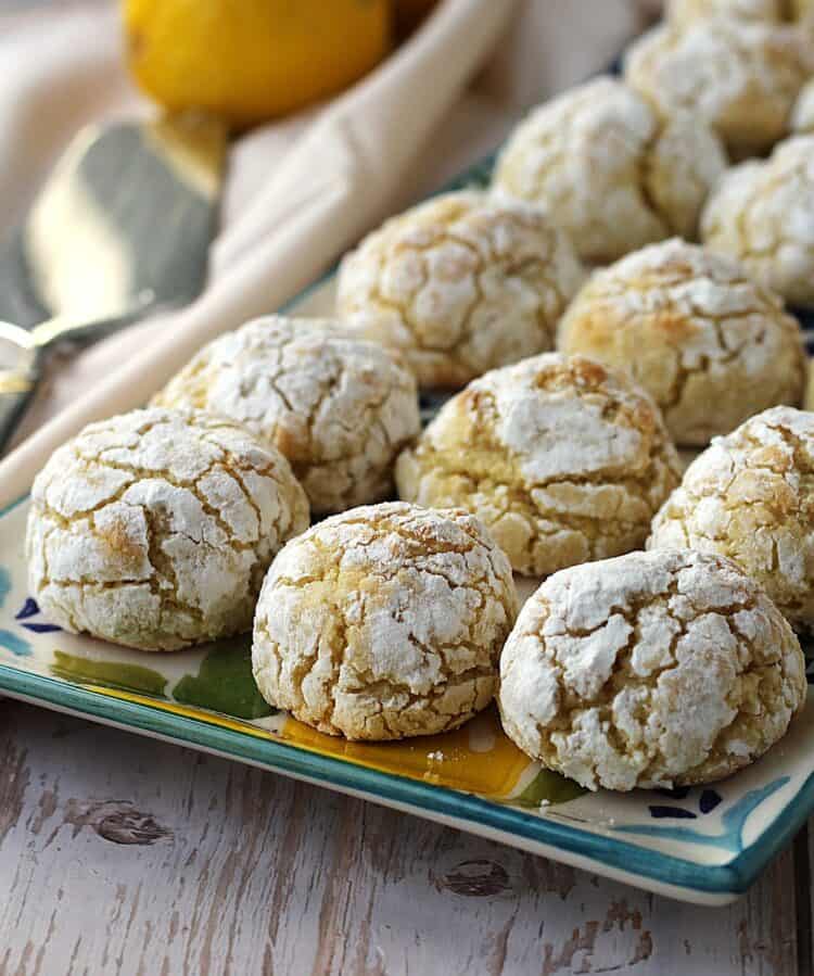 Crinkle lemon almond cookies on rectangular plate.