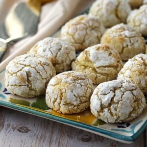 Lemon amaretti cookies with almond flour on rectangular serving plate.