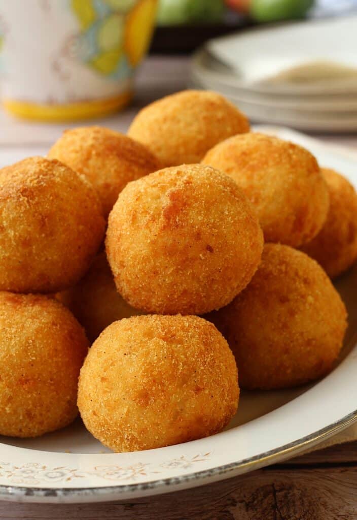 Arancini, rice balls, piled on serving plate.
