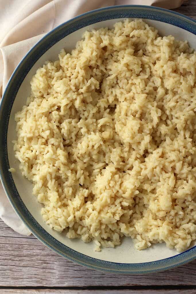 Cooked arborio rice in large bowl for arancini.