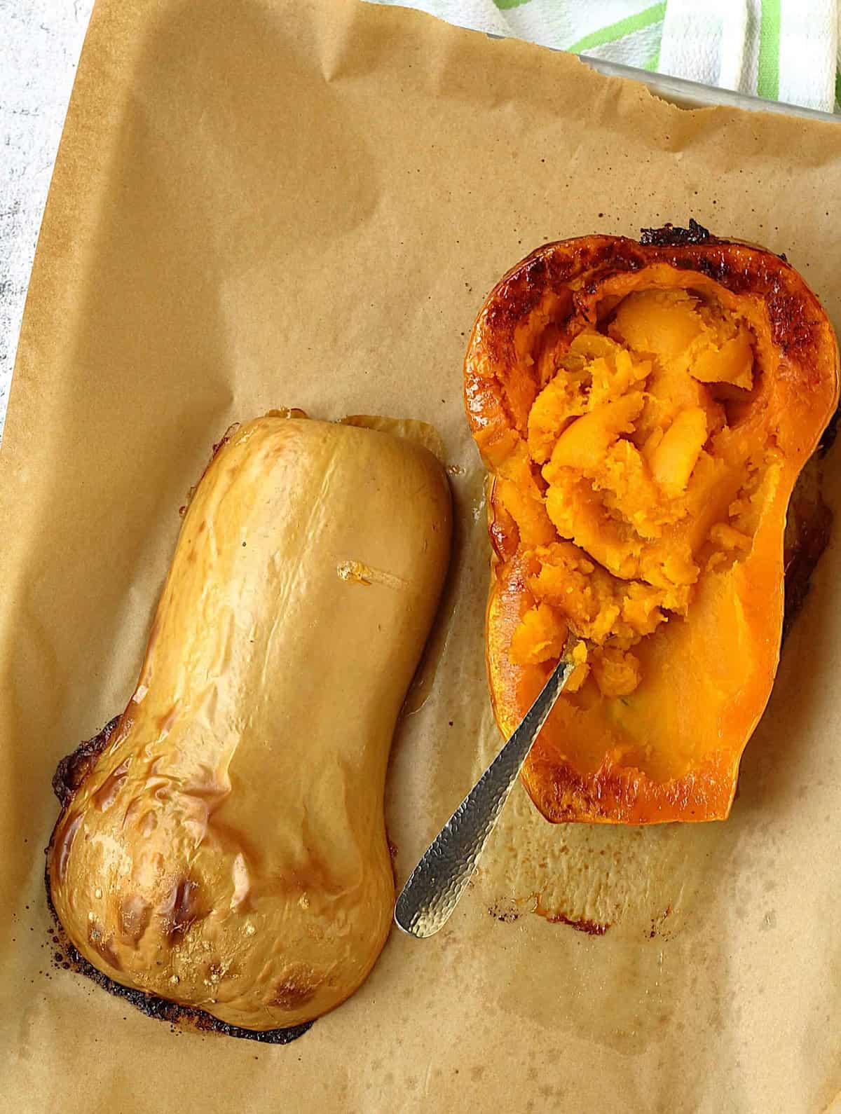 Roasted butternut squash halves for polenta lasagna filling.