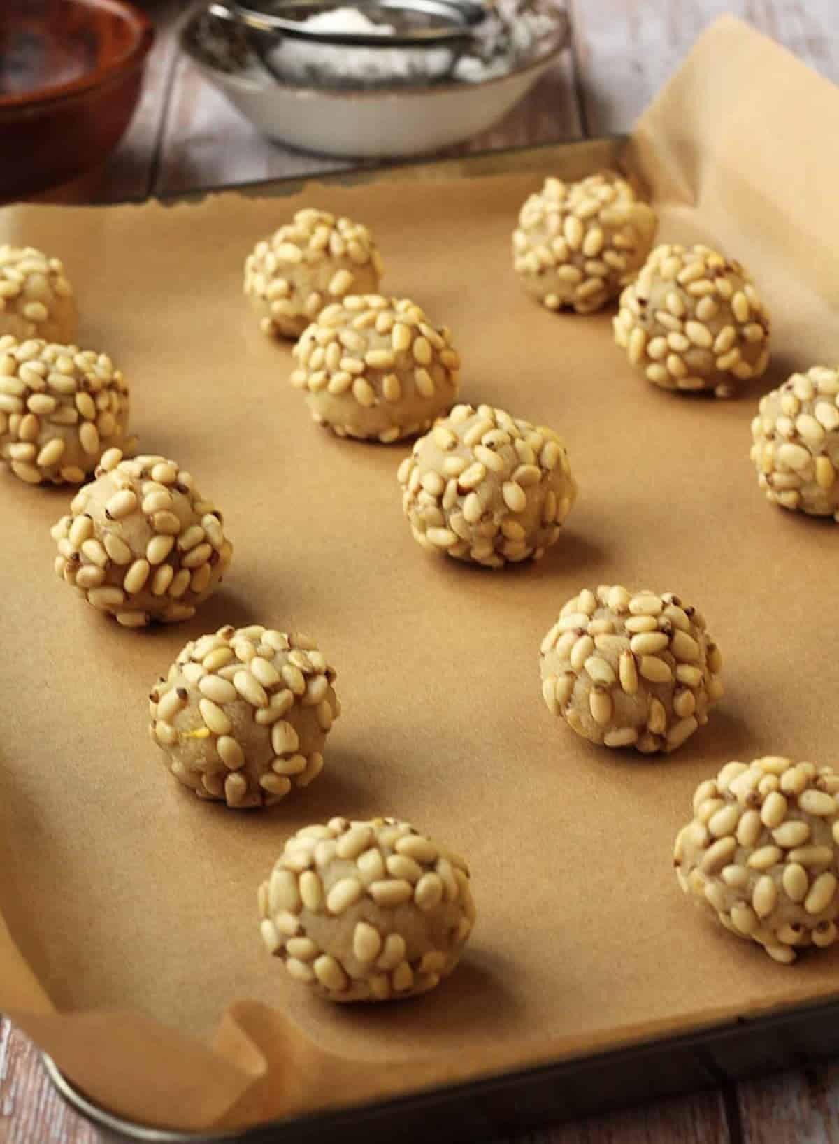 Pignoli cookies just out of the oven on baking sheet.