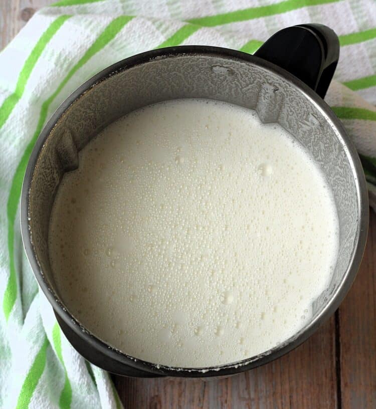 Almond milk in blender bowl.