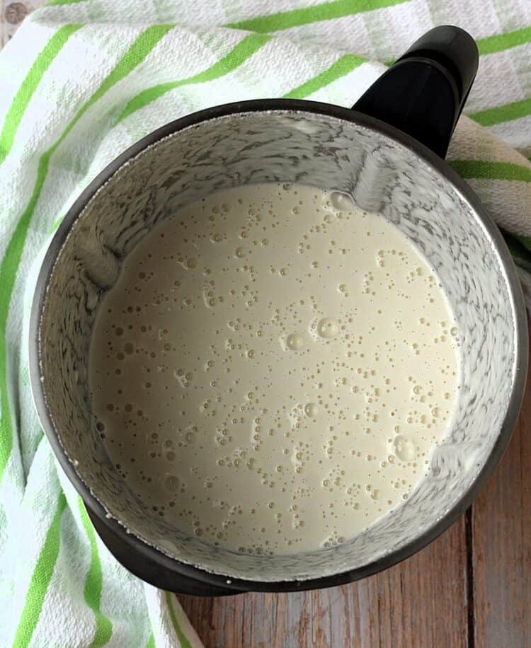 Almond milk in blender bowl.